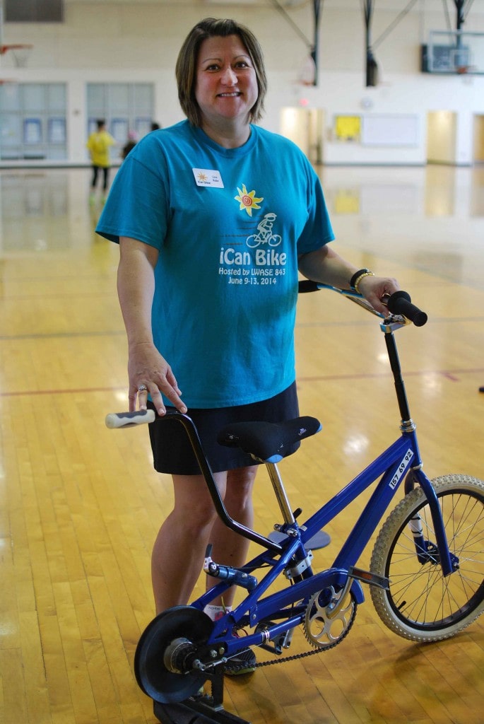 Founder and Executive Director Lisa Ruby stands with one of the bikes used for programming.