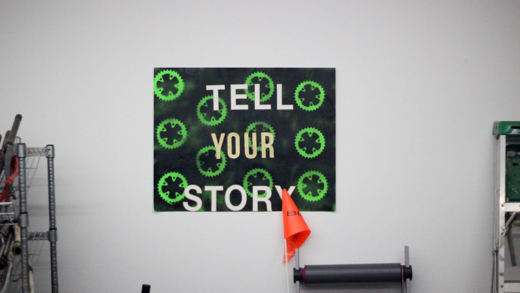 A sign in the Gearin' Up shop that reads "Tell your story"