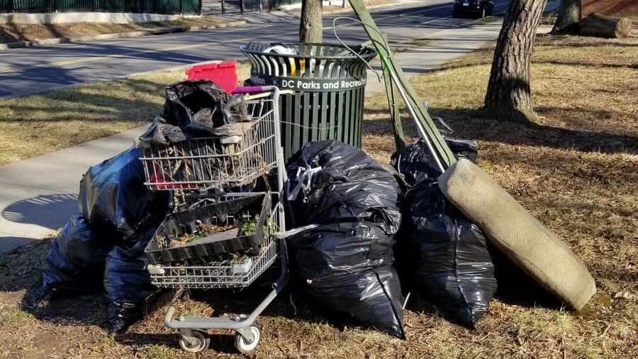 an overflowing trash bin on the Marvin Gaye Trail