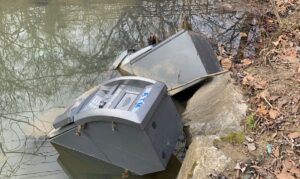 Two broken ATMs submerged in Watts Branch