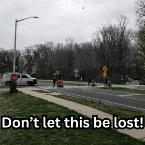 A crosswalk across Little Falls Parkway with the text, "Don't let this be lost!"