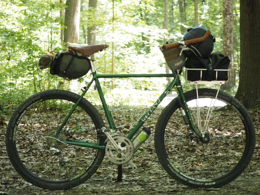 A green bicycle with a tray-shaped front rack.