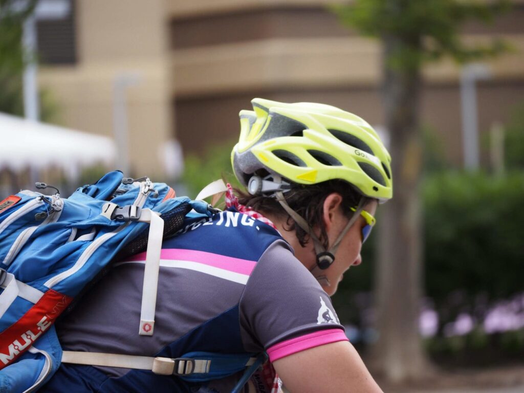 A person wearing a bike jersey with a backpack