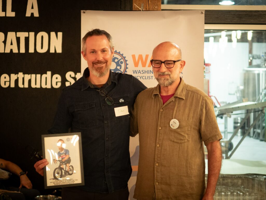 WABA Maryland Organizer Seth Grimes presented a Public Leadership Award  to Councilmember Eric Olson and a Community Advocate Award to Dan Behrend at the 2024 WABA Awards program